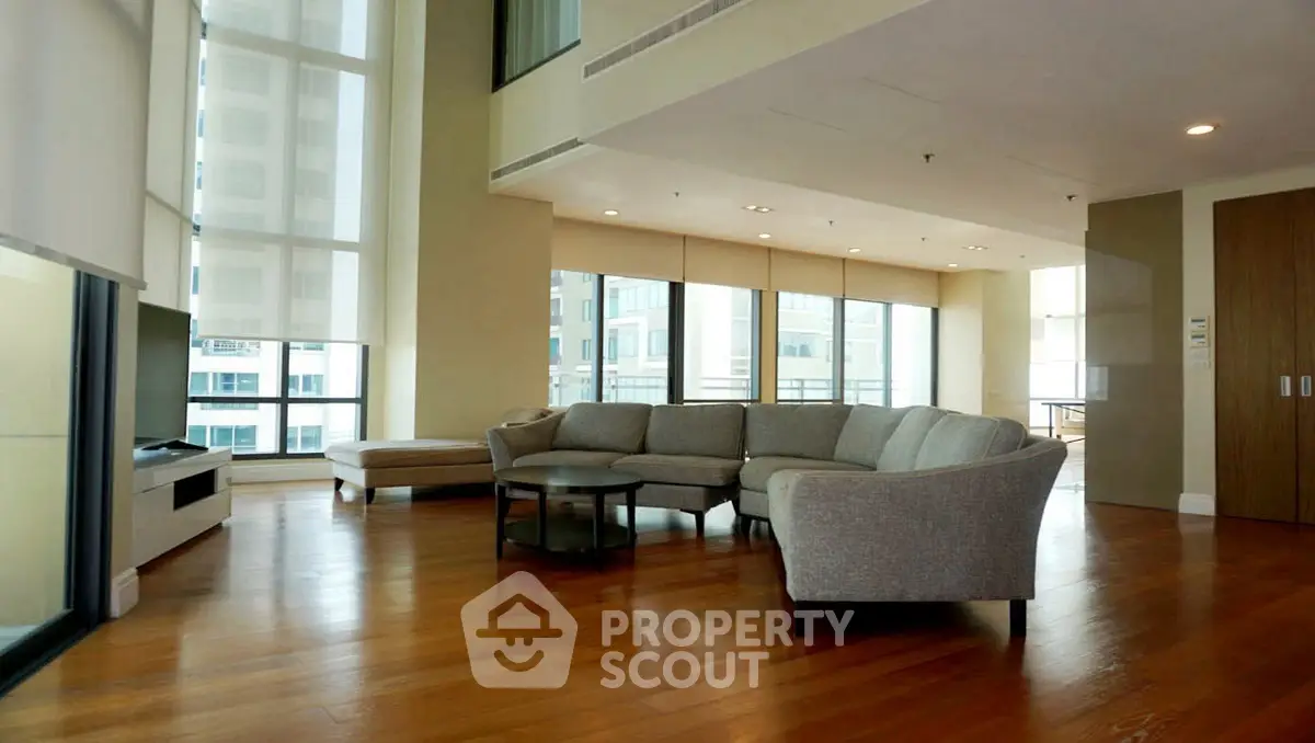 Spacious modern living room with large windows and elegant furniture
