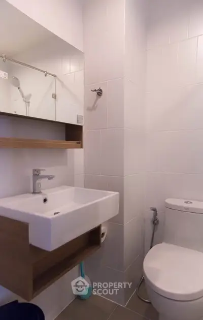 Modern bathroom with sleek white tiles and contemporary fixtures