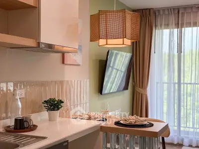 Modern kitchen with open layout and stylish decor, featuring a breakfast bar and large window view.