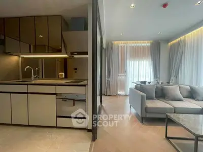 Modern open-layout kitchen and living room with sleek design and ample natural light.