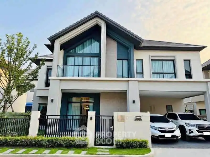 Modern two-story house with large windows and driveway in a suburban neighborhood.