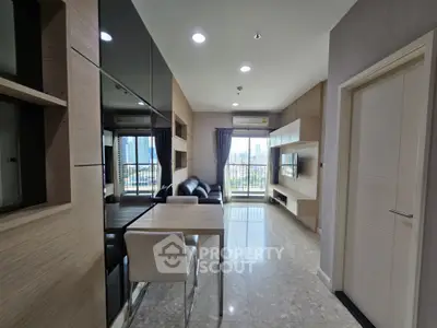 Modern living room with city view, sleek furniture, and stylish decor in a high-rise apartment.