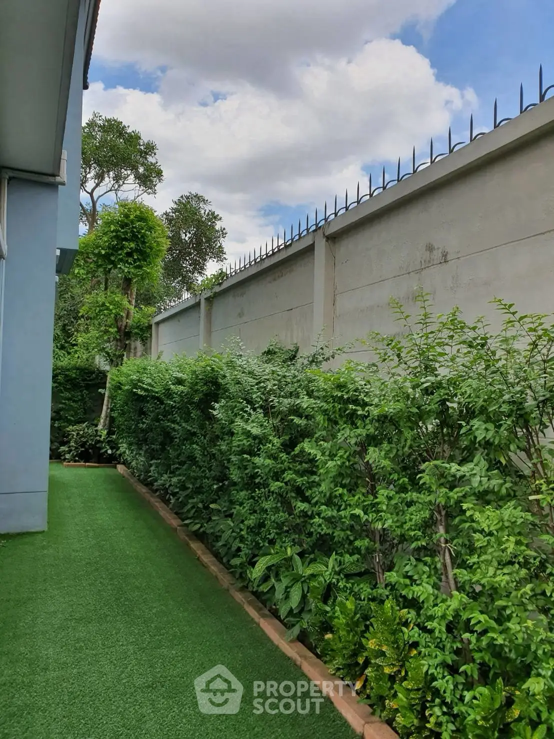 Lush garden view with manicured hedges and secure fencing, perfect for privacy and relaxation.