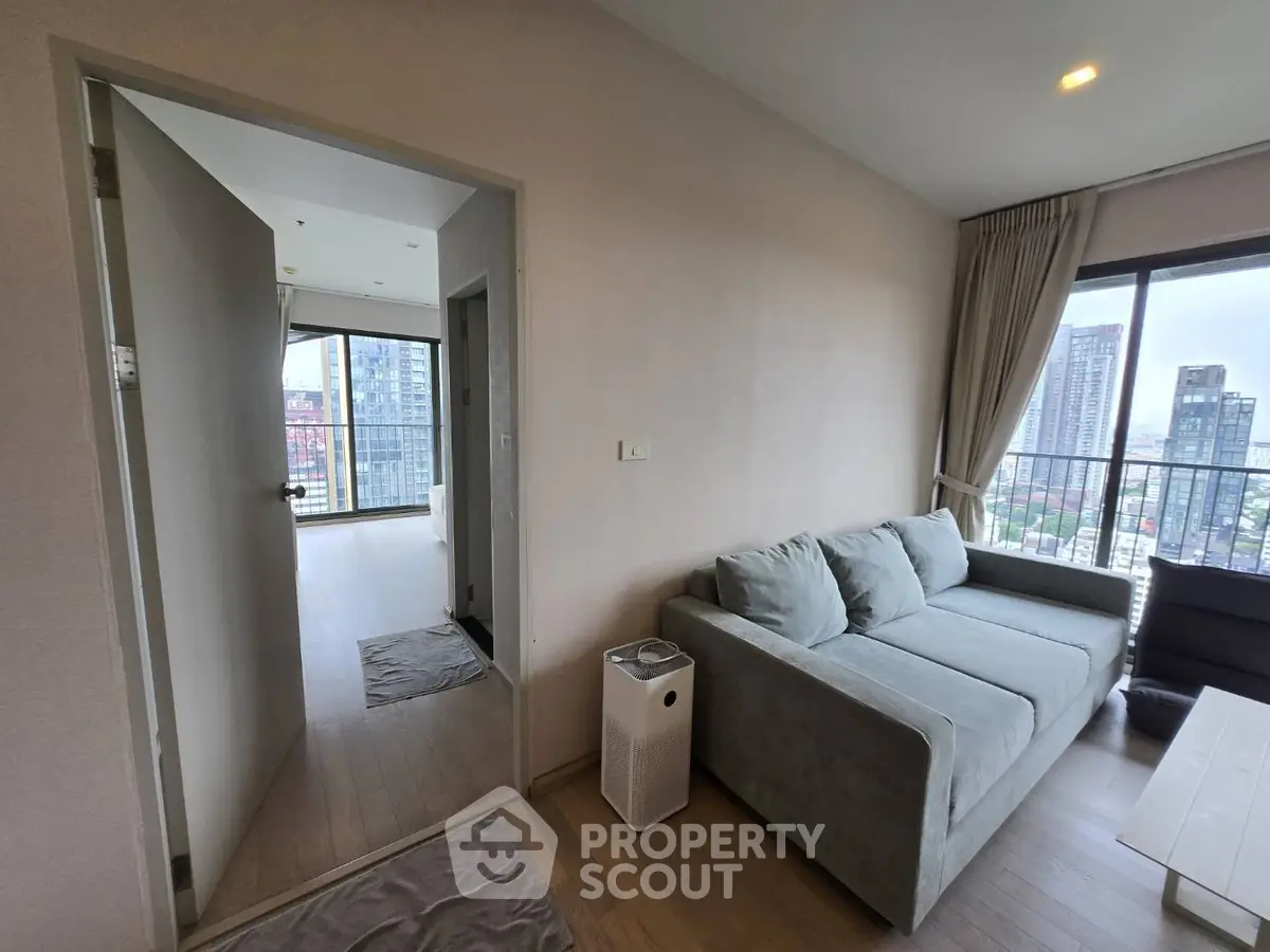 Modern living room with city view and stylish gray sofa