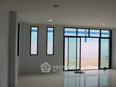 Spacious modern living room with large windows and sleek flooring