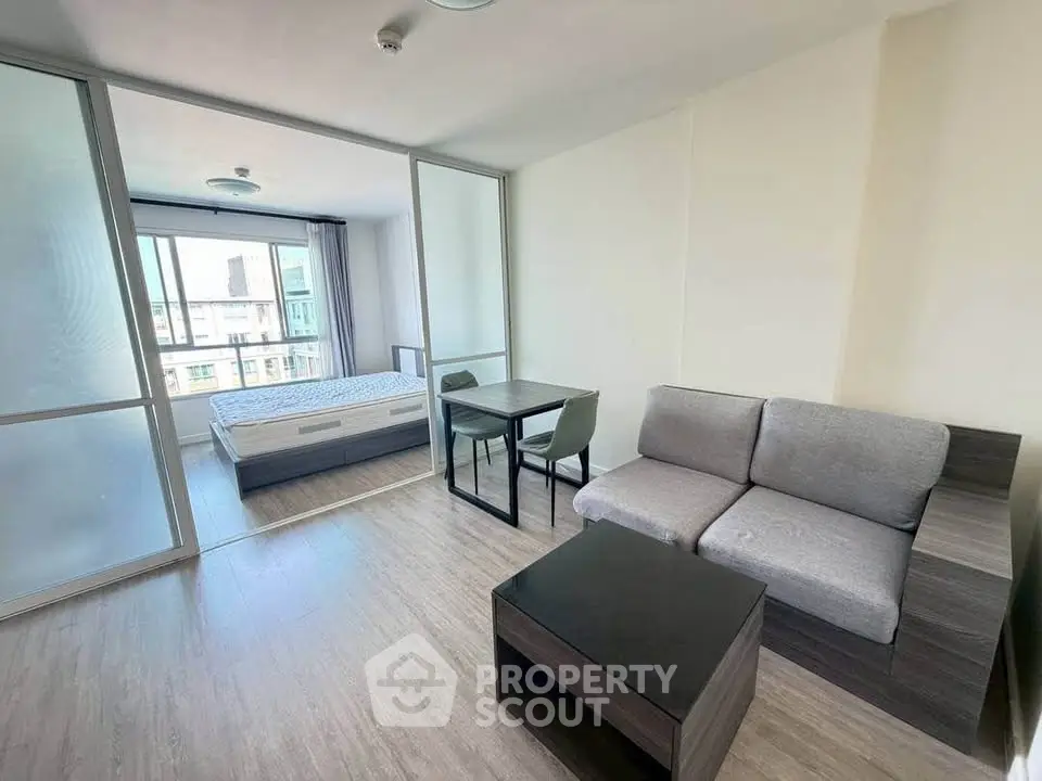 Modern studio apartment with sleek furniture and large windows