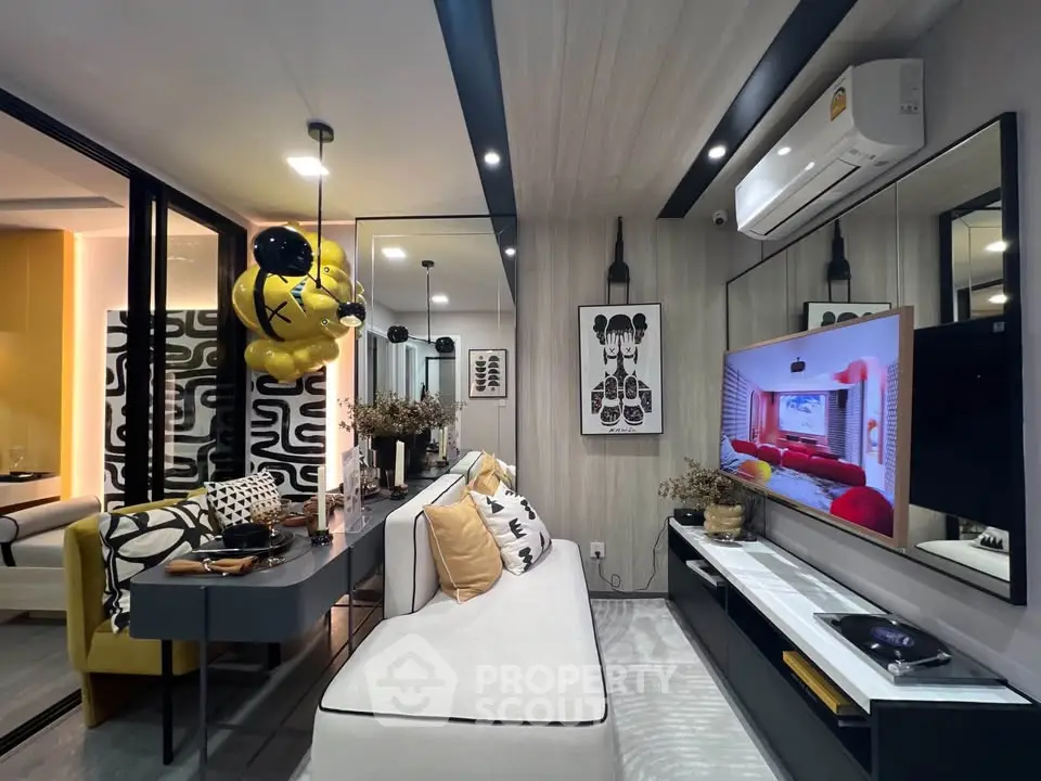 Modern living room with stylish decor and wall-mounted TV, featuring a cozy sofa and elegant lighting.