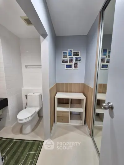 Modern bathroom with sleek design and decorative photo collage