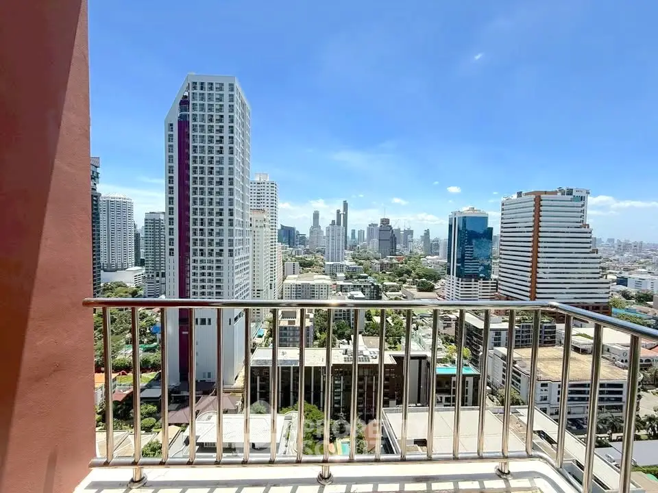 Stunning cityscape view from a high-rise balcony in a modern urban setting.