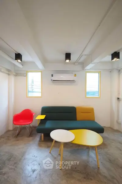 Modern living room with colorful furniture and minimalist design