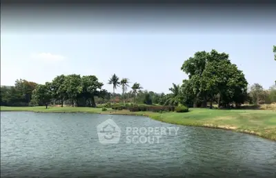 Scenic lakeside view with lush greenery and clear skies, perfect for tranquil living.