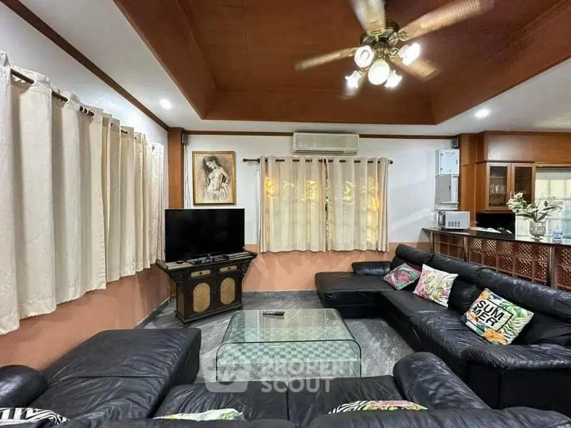 Spacious living room with leather sofas and modern decor