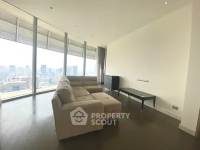 Spacious living room with panoramic city view and modern furniture.