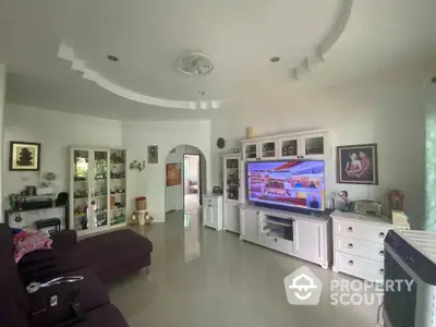 Spacious living room with modern decor and large TV unit