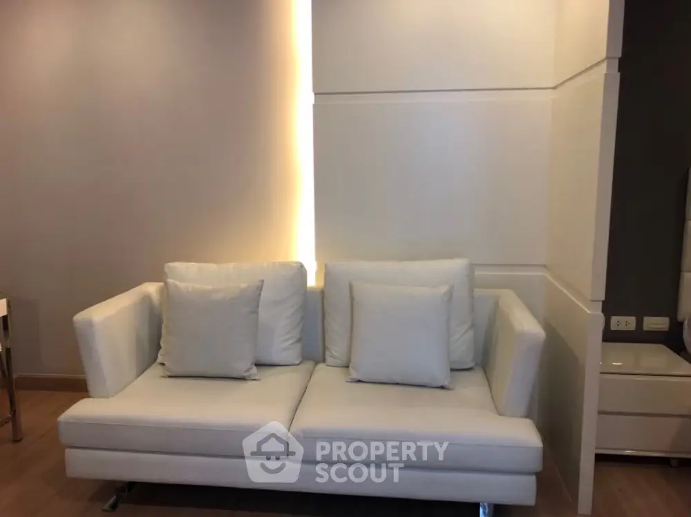 Modern living room with stylish white sofa and ambient lighting