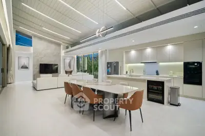 Luxurious open-plan living room and kitchen with modern design and elegant furnishings.