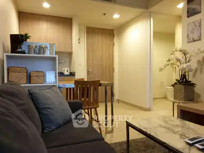 Modern living room with cozy sofa and stylish kitchen area