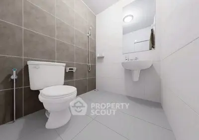 Modern minimalist bathroom with sleek fixtures and neutral tiles.