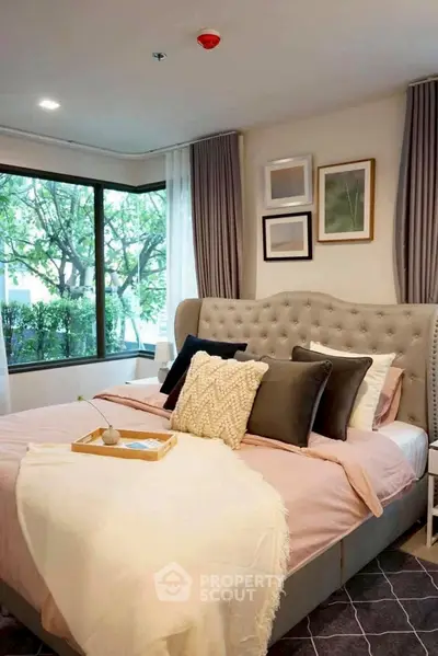 Luxurious bedroom with plush bedding and large window view