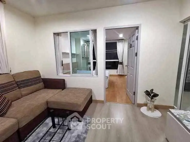 Modern living room with cozy sectional sofa and stylish decor in a well-lit apartment.