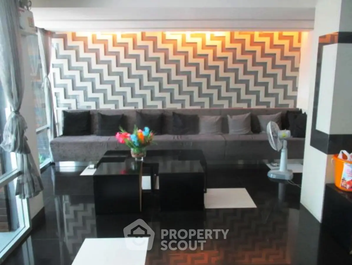 Stylish living room with modern zigzag wall design and sleek black flooring