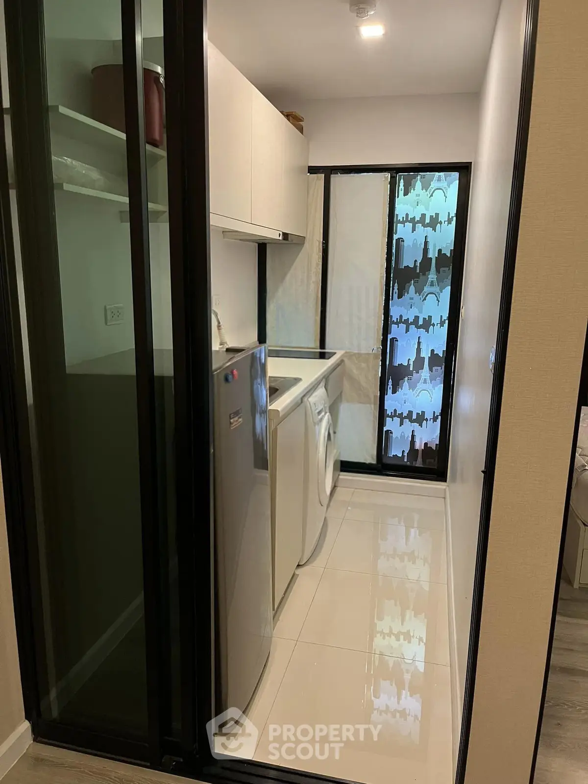 Modern laundry room with washing machine and sleek storage cabinets