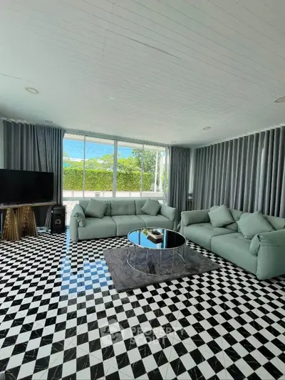 Spacious living room with modern decor and large windows offering natural light.