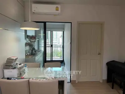 Modern apartment dining area with kitchen and balcony view
