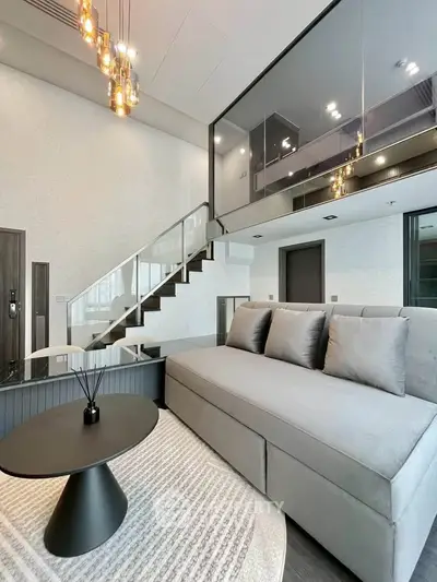 Modern duplex living room with stylish decor and mezzanine level