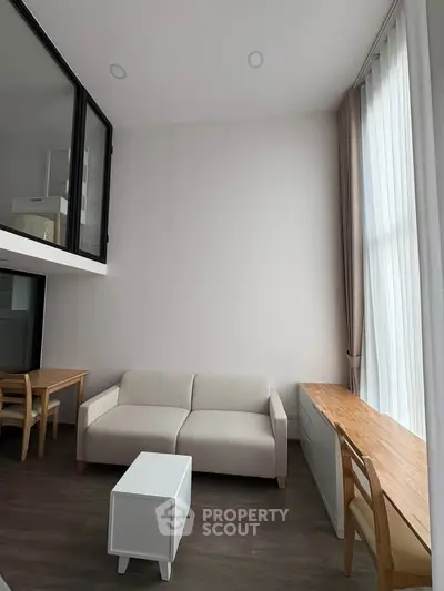 Modern living room with high ceiling and minimalist furniture design