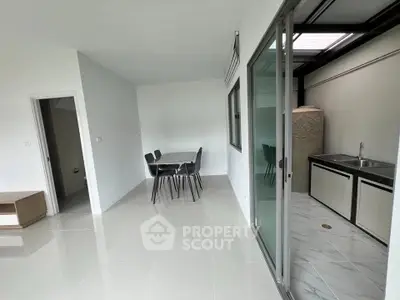 Modern open-plan living area with sleek kitchen and dining space