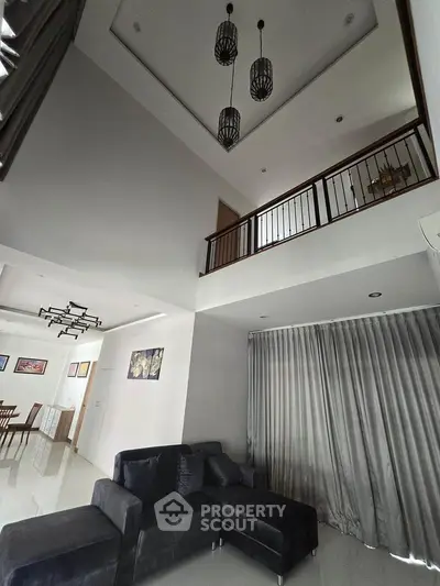 Spacious modern living room with high ceiling and elegant decor