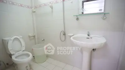 Spacious bathroom with modern fixtures and white tile design, perfect for a clean and fresh look.