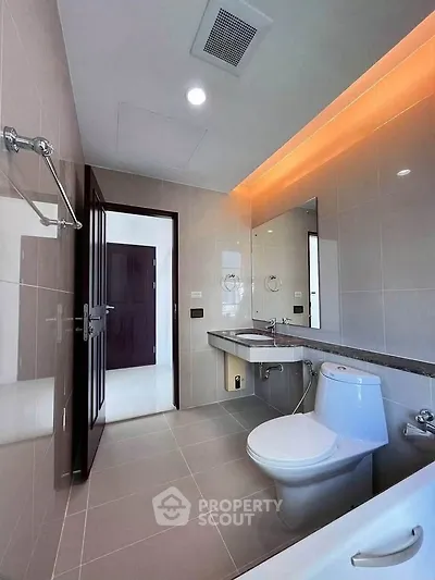 Modern bathroom with sleek fixtures and ambient lighting in a contemporary home.