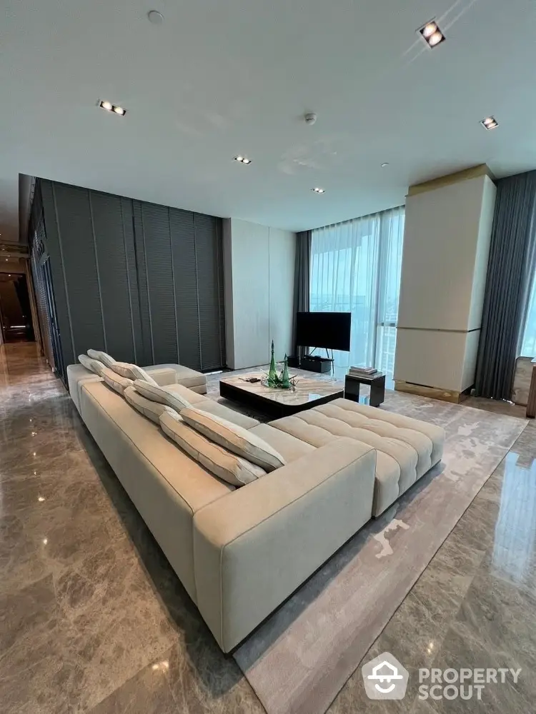 Luxurious modern living room with plush sectional sofa and panoramic city views