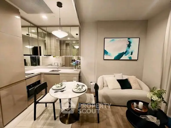 Modern open-layout kitchen and cozy living area with stylish decor and dining setup.