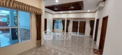 Spacious living room with elegant ceiling design and large windows for natural light.