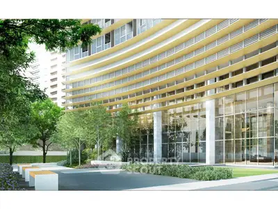 Modern building exterior with glass facade and landscaped garden