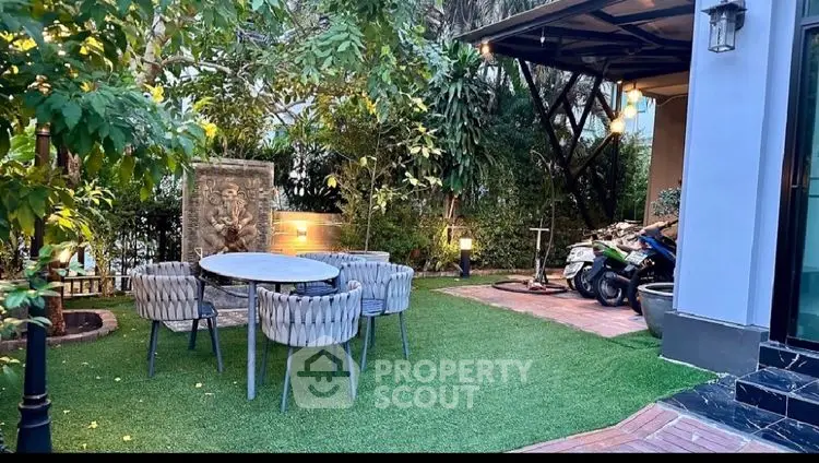 Charming garden with outdoor dining area and lush greenery