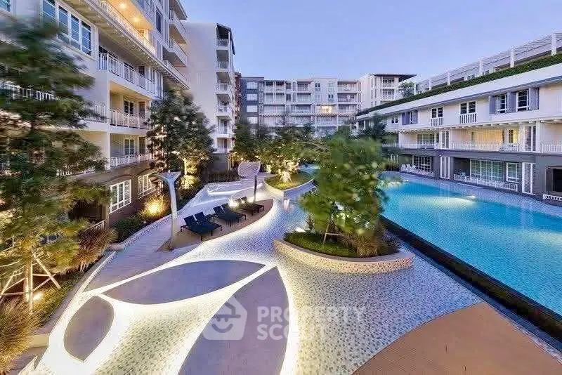 Luxurious modern apartment complex with stunning pool and landscaped surroundings.
