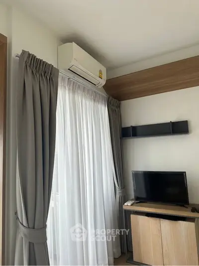 Modern living room with air conditioning and stylish curtains