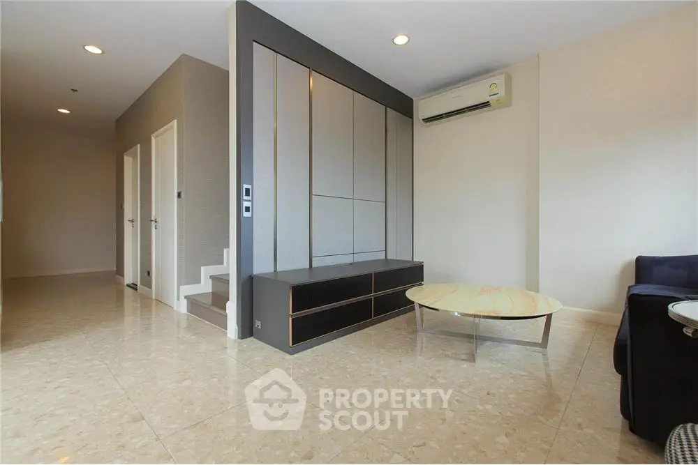 Modern living room with sleek design and air conditioning unit