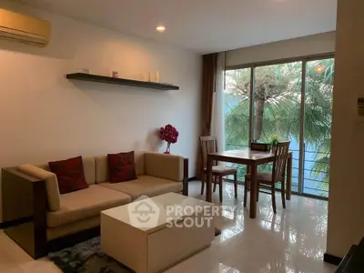 Modern living room with cozy sofa, dining area, and large window view.
