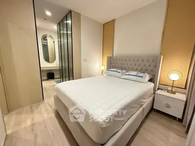 Modern bedroom with elegant decor and spacious design, featuring a plush bed and stylish lighting.