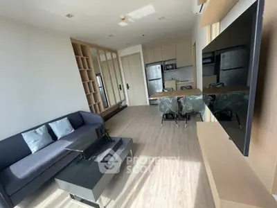 Modern living room with sleek furniture and open kitchen layout