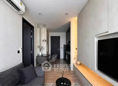 Modern living room with sleek design, featuring a cozy sofa, wall-mounted TV, and stylish decor.