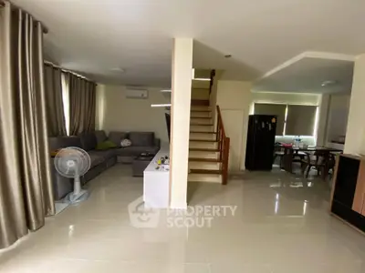 Spacious living room with modern furniture and open dining area