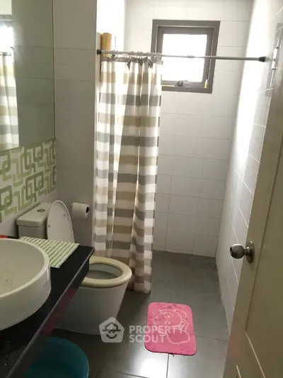 Cozy bathroom with modern fixtures and stylish shower curtain