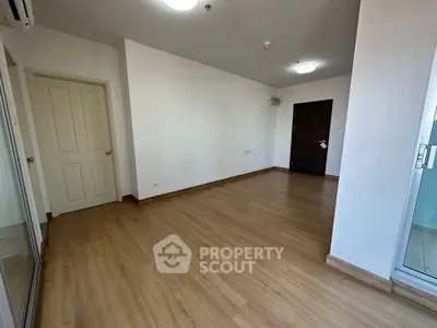 Spacious empty living room with wooden flooring and modern lighting