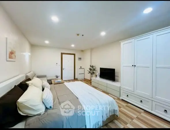 Spacious modern bedroom with stylish decor and ample storage space